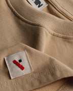 Oversized Cotton Basics Beige oversized cotton t-shirt with relaxed fit and subtle embroidery on edge