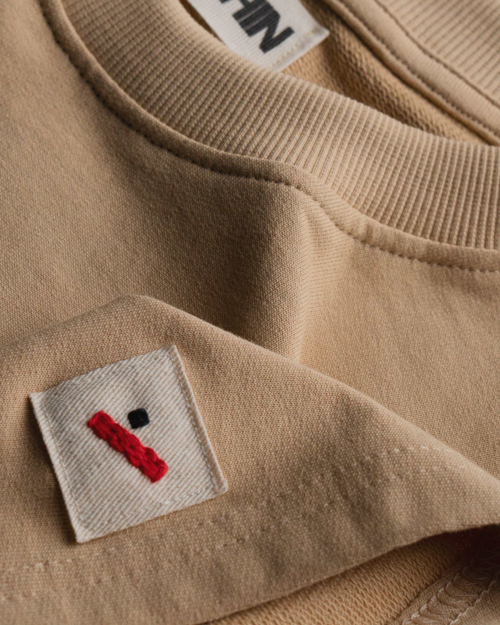 Oversized Cotton Basics Beige oversized cotton t-shirt with relaxed fit and subtle embroidery on edge