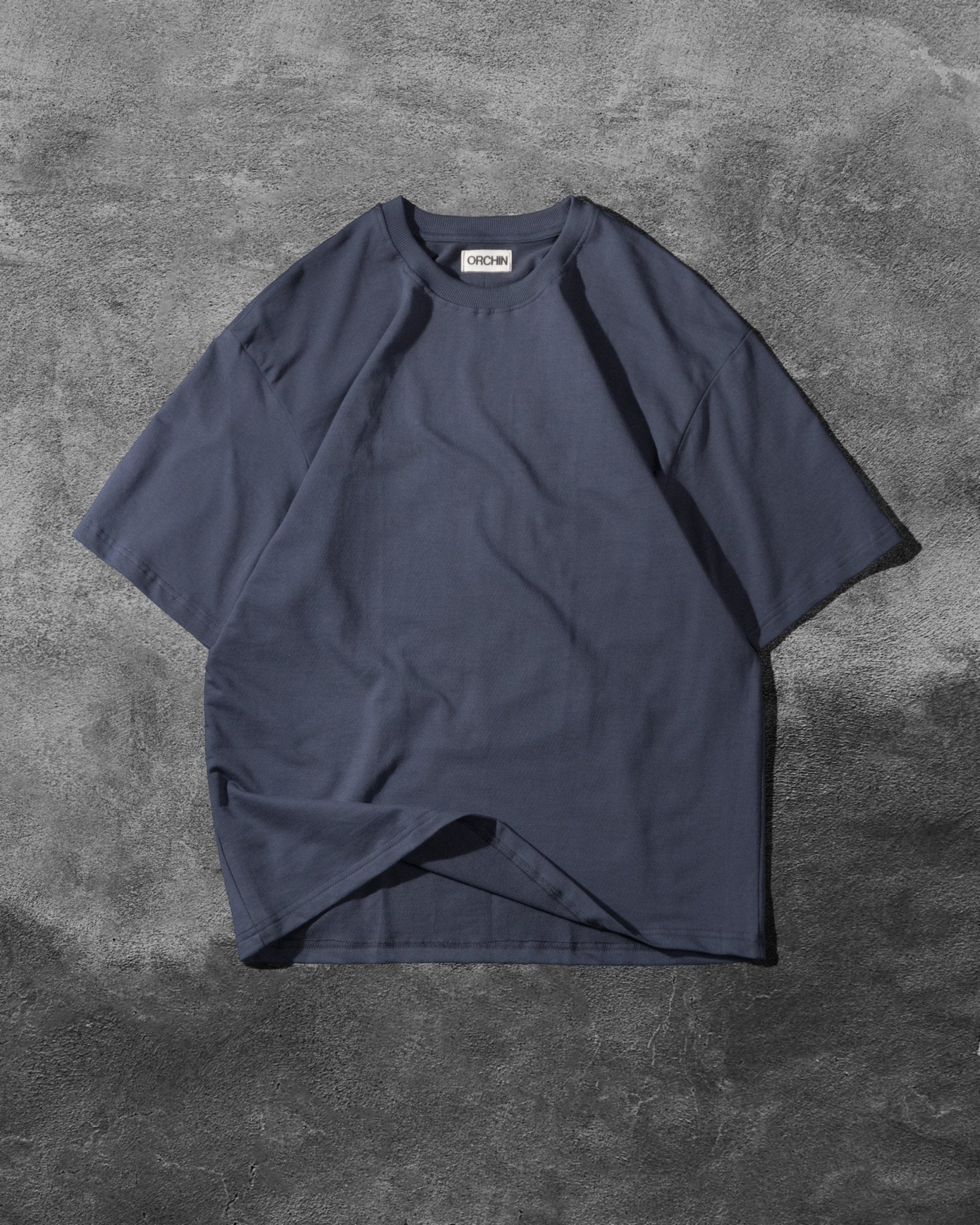 Oversized Cotton Basics iron grey relaxed fit cotton t-shirt on concrete background